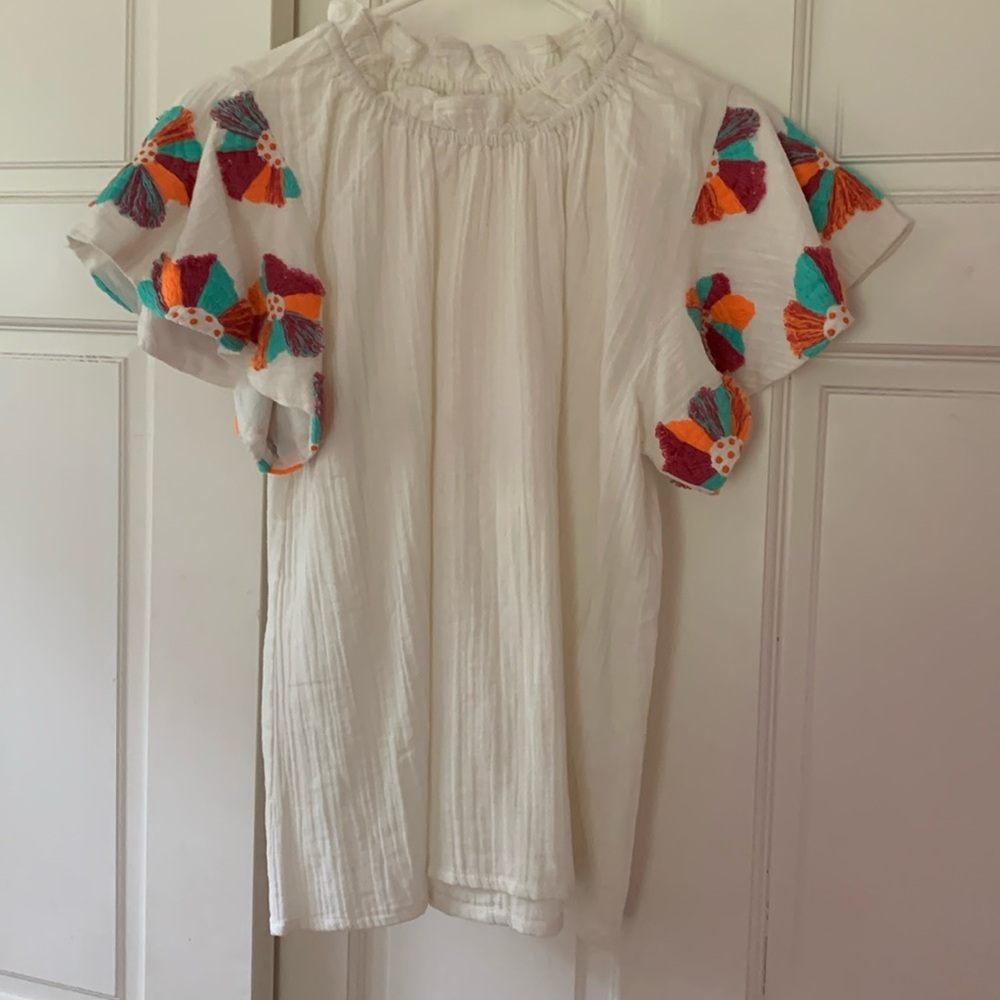 THML women’s size small. White with embroidered design on sleeves.